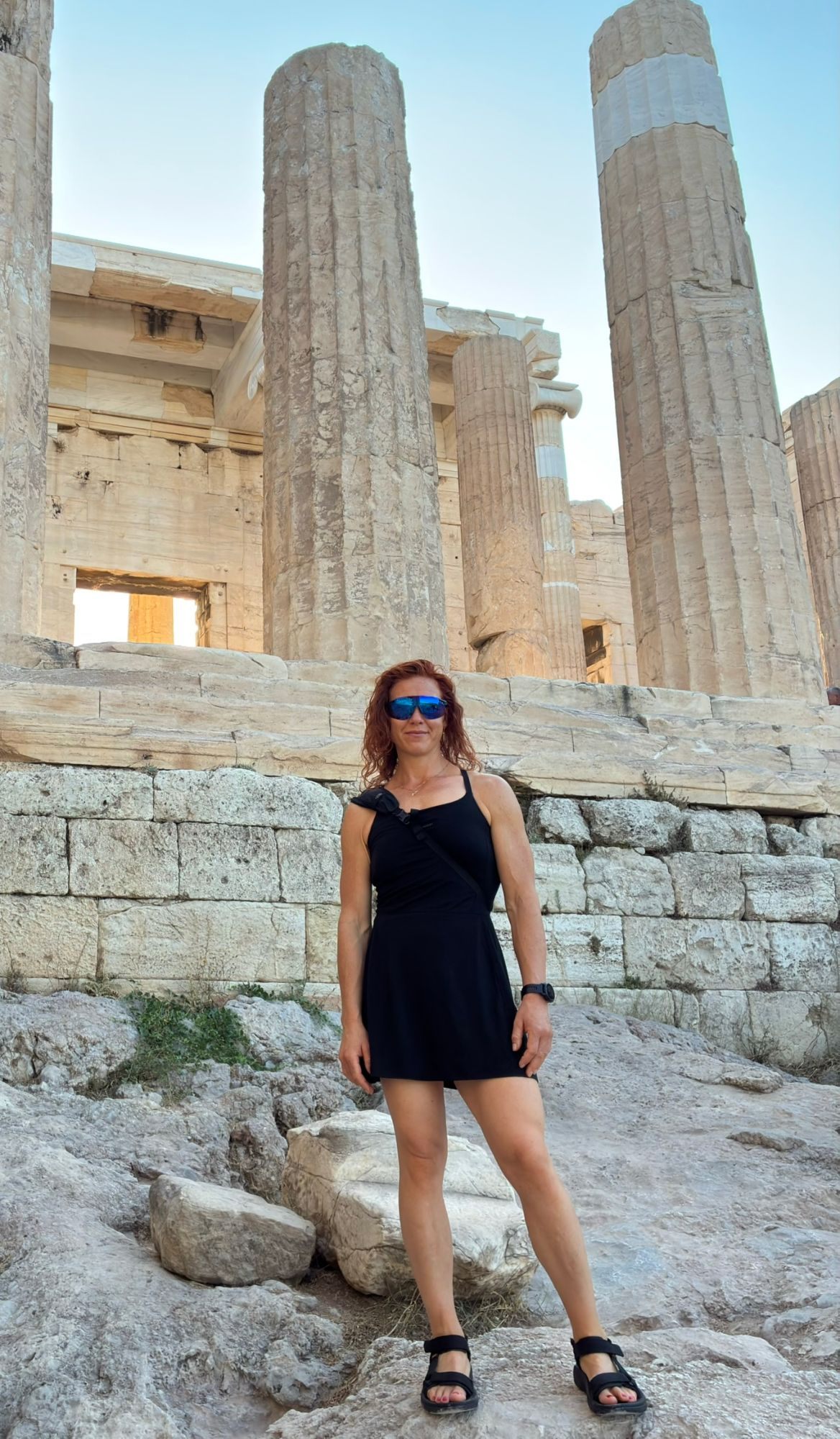 Kristine standing below the columns of the Propylaea, the gateway to the Acropolis
