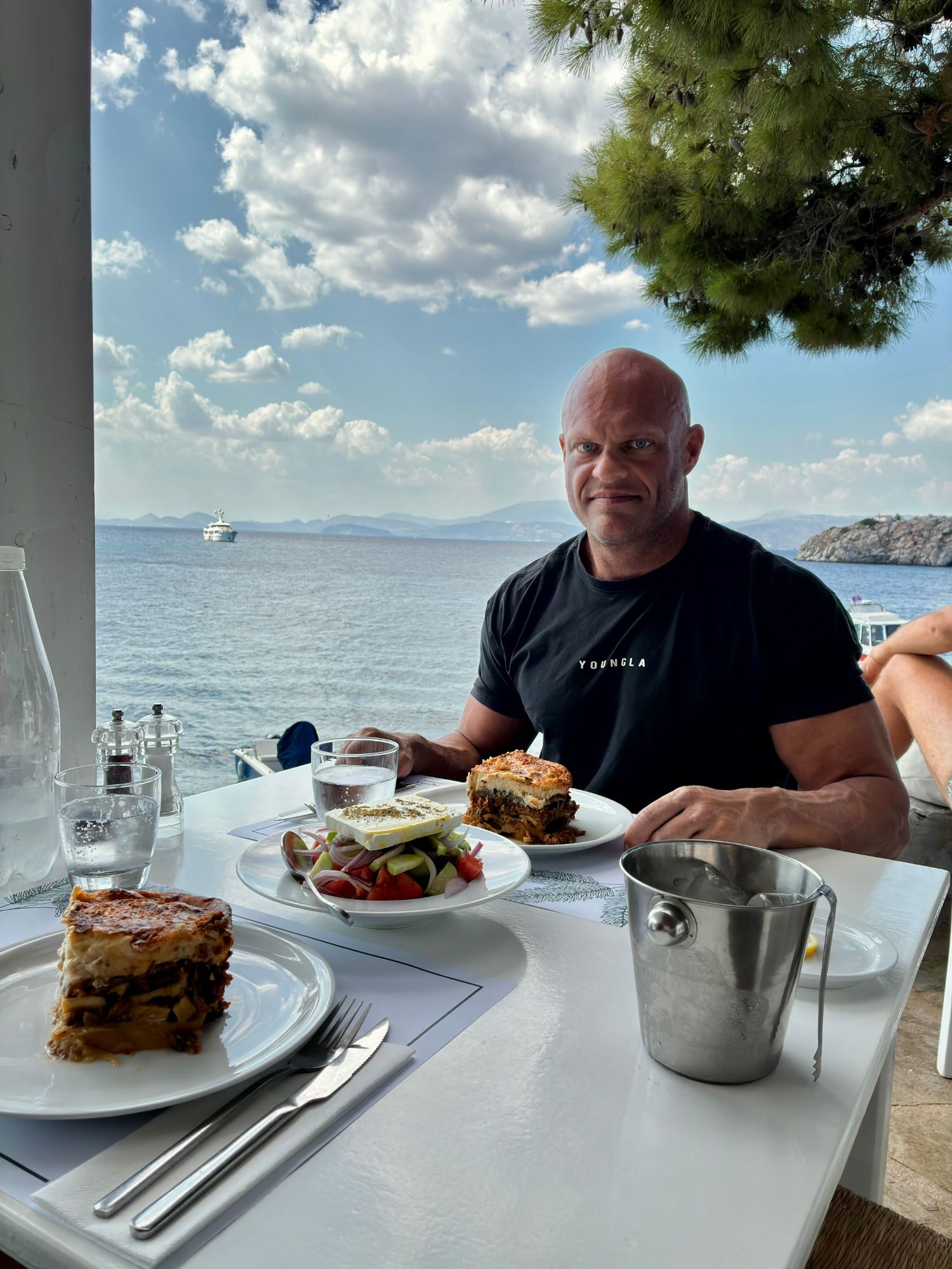 Moussaka and Greek salad on a table by the sea at Taverna Marina near Vlychos