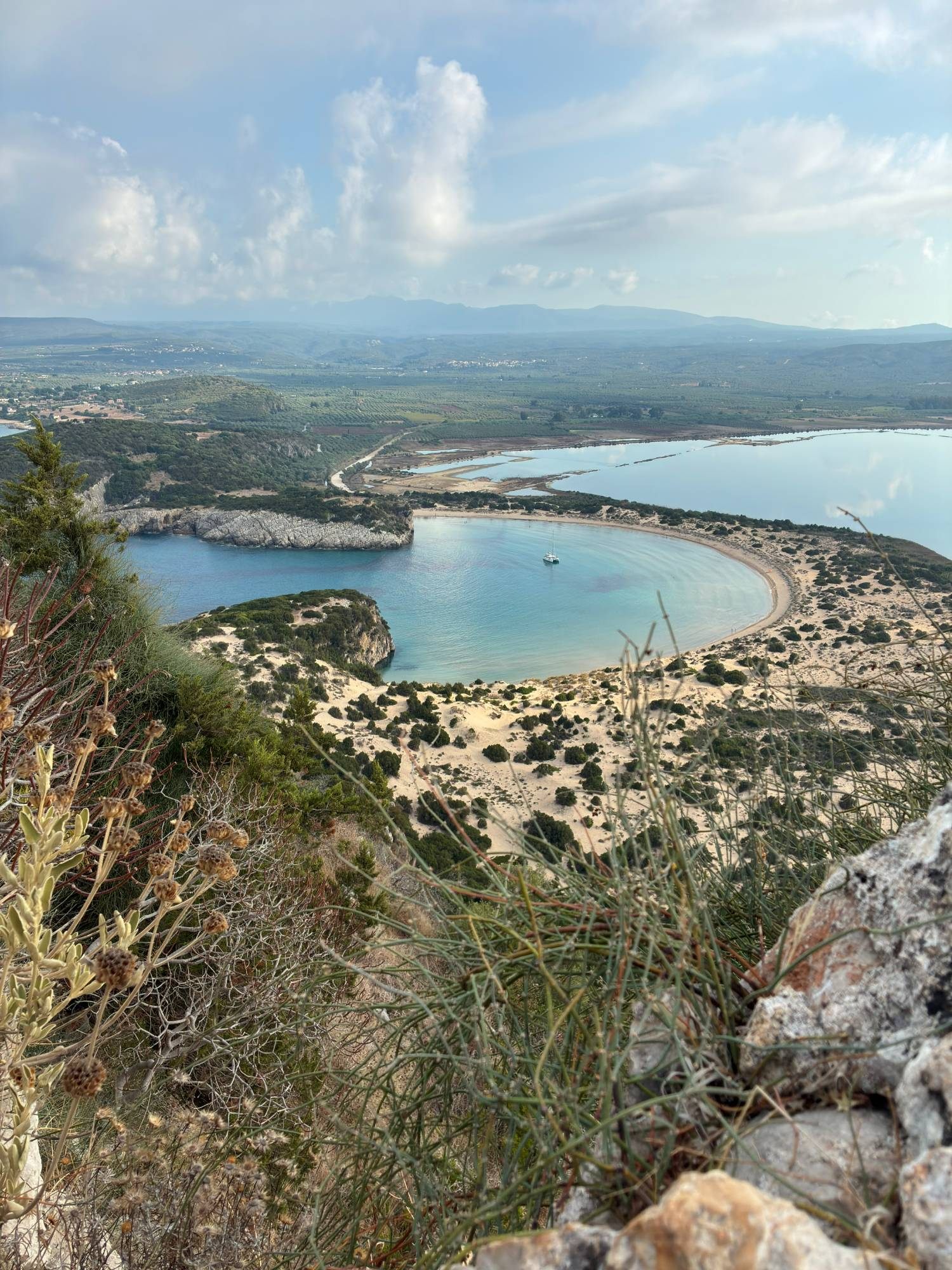 Voidokilia Beach seen from above near Old Navarino Castle – a perfect omega-shaped bay with Gialova Lagoon behind