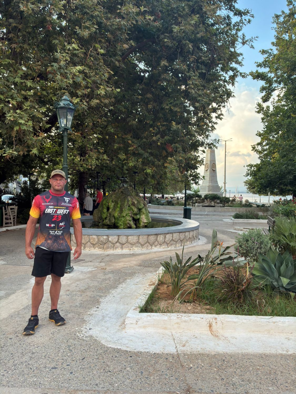 The leafy main square of Pylos with the Navarino monument in the background